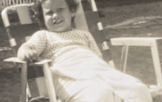 A young Marla reclines in a lawn chair - black and white photo