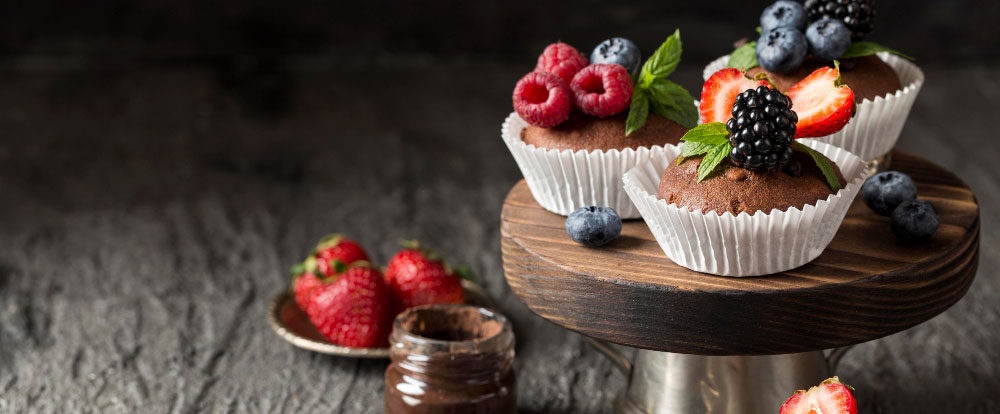 cupcakes with berries on a serving stand
