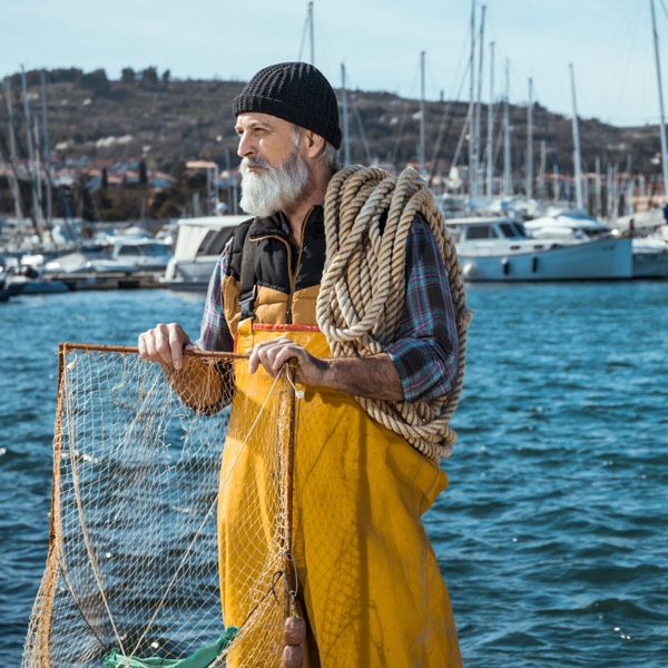 fisherman in front of water with rope